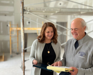 A construction loan lender reviewing documents with a contractor